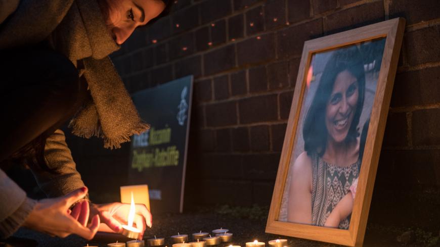LONDON, ENGLAND - JANUARY 16:  A woman lights candles marking the number of days Nazanin Zaghari-Ratcliffe has been imprisoned for next to a photo of her during a vigil for British-Iranian mother, Nazanin Zaghari-Ratcliffe, imprisoned in Tehran outisde the Iranian Embassy on January 16, 2017 in London, England. Charity worker Nazanin Zaghari-Ratcliffe was jailed for five years in September 2016 for allegedly attempting to overthrow the Iranian government. The vigil, being held outside the Iranian Embassy in