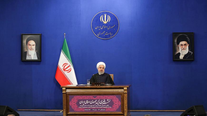 Iranian President Hassan Rouhani speaks during a news conference in the capital Tehran, on February 16, 2020, with the portraits of Iran's (L to R) former and current Supreme Leaders, Ayatollah Ruhollah Khomeini and Ayatollah Ali Khamenei, seen behind. - Iran's President Hassan Rouhani ruled out resigning and vowed to see out his term, even as he admitted he had offered to step aside twice since being elected. Speaking ahead of a general election next Friday, Rouhani also appealed to voters to turn out desp