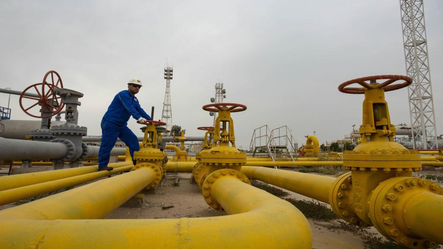 An employee turns a valve at the Nahr Bin Omar natural gas field, north of the southern Iraqi port of Basra on April 21, 2020. (Photo by Hussein FALEH / AFP) (Photo by HUSSEIN FALEH/AFP via Getty Images)