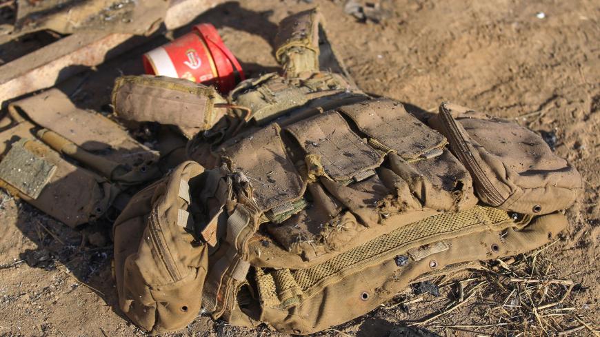 Damaged military gear is scattered on the ground at the site of an Islamic State (IS) group attack, a day earlier, on a unit of Iraq's Hashed al-Shaabi (Popular Mobilisation Forces) in Mukaishefah, about 180km (110 miles) north of the capital, on May 3, 2020. - IS group remnants in Iraq are exploiting a coronavirus lockdown, coalition troop withdrawals and simmering political disputes to ramp up deadly attacks, according to analysts and intelligence officials, the bloodiest so far being an ambush early on M