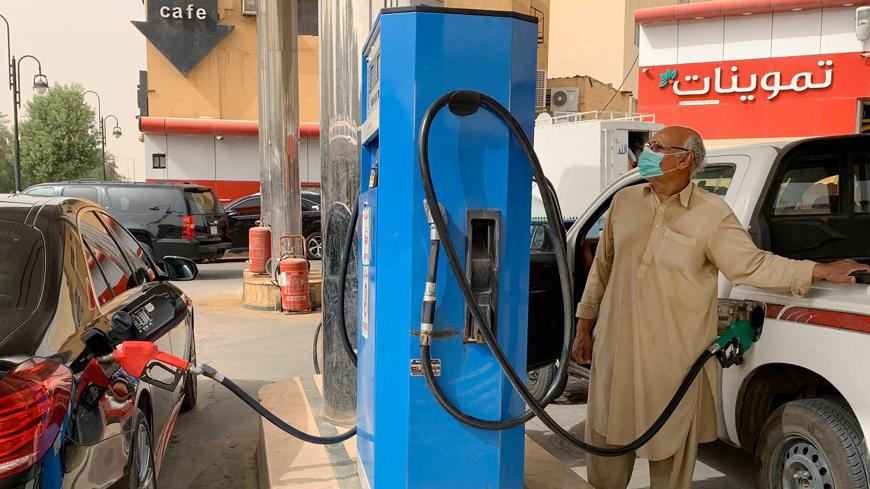 A man refills his car at a gas station in the Saudi capital Riyadh on May 11, 2020. - Saudi Arabia's energy ministry said it had asked oil giant Aramco to make an additional voluntary output cut of one million barrels per day starting from June to support prices. The move will reduce the production of the world's biggest crude exporter to 7.5 million barrels per day, the energy ministry said in a statement cited by the official Saudi Press Agency. (Photo by RANIA SANJAR / AFP) (Photo by RANIA SANJAR/AFP via