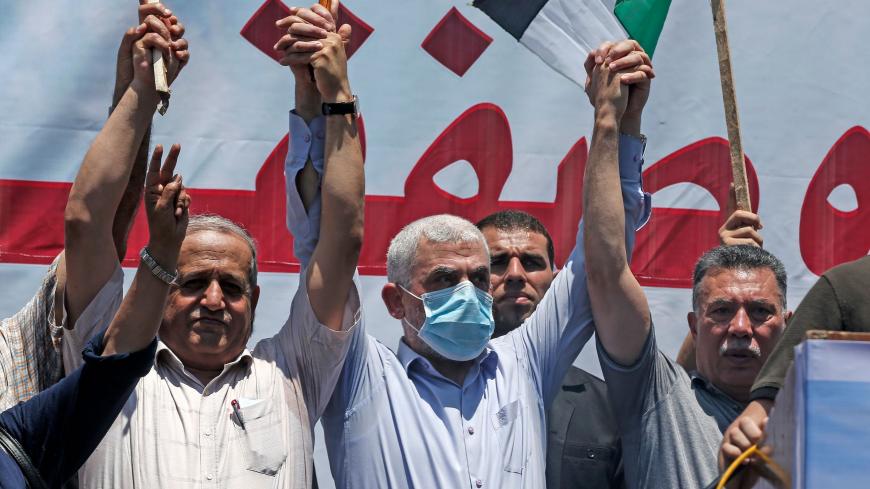 Hamas leader Yahya Sinwar (C) takes part in a rally as Palestinians call for a "Day of Rage" to protest Israel's plan to annex parts of the occupied West Bank, in Gaza City on July 1, 2020. - Expectations of a major Israeli announcement on controversial annexations in the occupied West Bank dimmed, as global criticism of the project mounted and Palestinian protesters began gathering in Gaza. (Photo by MAHMUD HAMS / AFP) (Photo by MAHMUD HAMS/AFP via Getty Images)
