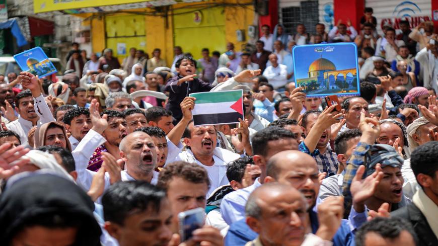 Demonstrators chant slogans with signs depicting Jerusalem's Dome of the Rock and flags of Palestine during a protest in Yemen's third city of Taez on August 21, 2020, against the US-brokered deal between the United Arab Emirates and Israel to normalise relations. (Photo by AHMAD AL-BASHA / AFP) (Photo by AHMAD AL-BASHA/AFP via Getty Images)