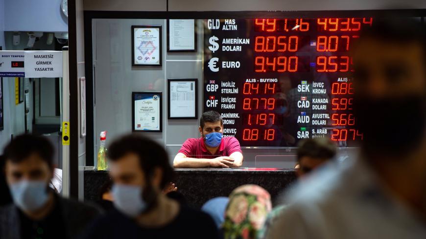 A currency exchange office worker works at an exchange office in Istanbul, on August 6, 2020 as Turkey's lira set a new record low against the US dollar. - Turkey's lira was trading at 8.03 against the dollar at around 0730 GMT, suffering a loss of nearly one percent since the beginning of the day. The Turkish currency also recorded its lowest level against the euro, trading near 9.52. (Photo by Yasin AKGUL / AFP) (Photo by YASIN AKGUL/AFP via Getty Images)