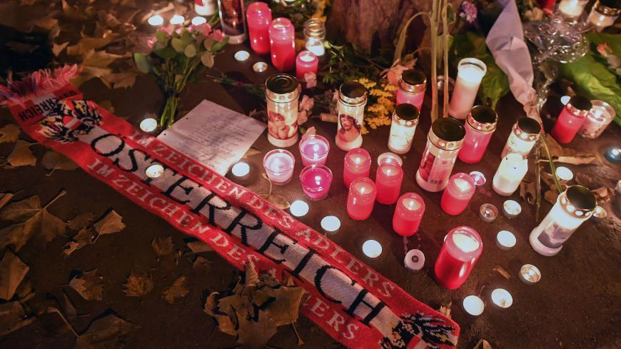 Flowers, candles and an Austria scarf are left at a memorial site at the scene of an attack in Vienna, Austria on November 3, 2020, one day after a shooting at multiple locations across central Vienna. - A huge manhunt was under way after gunmen opened fire at multiple locations across central Vienna in the evening of November 2, 2020, killing at least four people in what Austrian Chancellor Sebastian Kurz described as a "repulsive terror attack". (Photo by JOE KLAMAR / AFP) (Photo by JOE KLAMAR/AFP via Get