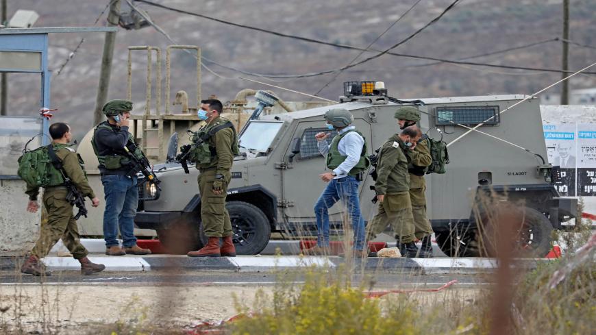 Israeli soldiers gather at a checkpoint near Nablus in the occupied West Bank where a Palestinian who shot at Israeli troops on November 4, 2020 was killed when soldiers returned fire, Israel's army said. (Photo by JAAFAR ASHTIYEH / AFP) (Photo by JAAFAR ASHTIYEH/AFP via Getty Images)