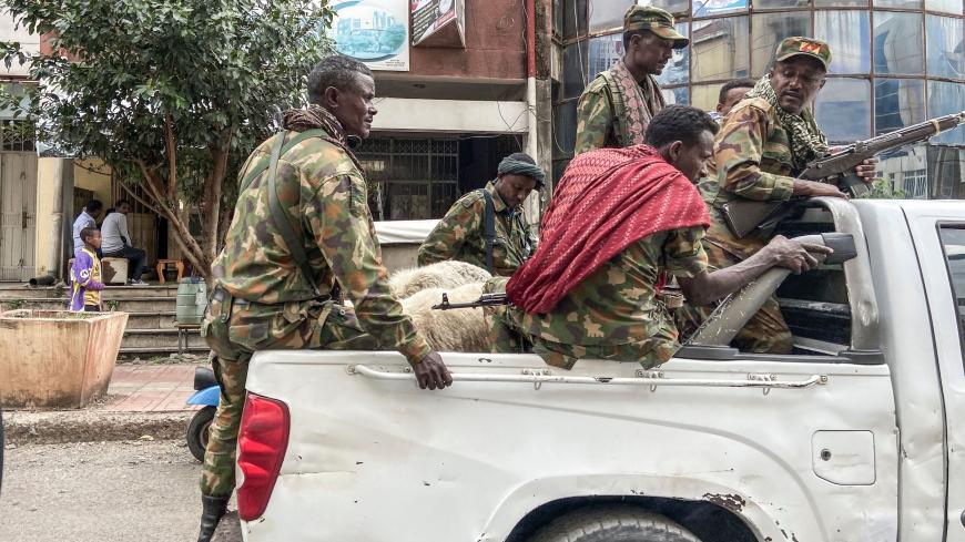 TOPSHOT - Members of the Amhara militia, that combat alongside federal and regional forces against northern region of Tigray, ride on the back of a pick up truck in the city of Gondar, on 08 November 2020. (Photo by EDUARDO SOTERAS / AFP) (Photo by EDUARDO SOTERAS/AFP via Getty Images)