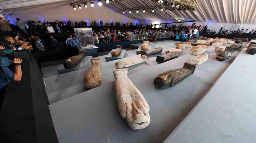 A picture shows wooden sarcophagi on display during the unveiling of an ancient treasure trove of more than a 100 intact sarcophagi, at the Saqqara necropolis 30 kms south of the Egyptian capital Cairo, on November 14, 2020. - Egypt announced the discovery of an ancient treasure trove of more than a 100 intact sarcophagi, the largest such find this year. The sealed wooden coffins, unveiled on site amid fanfare, belonged to top officials of the Late Period and the Ptolemaic period of ancient Egypt. They were