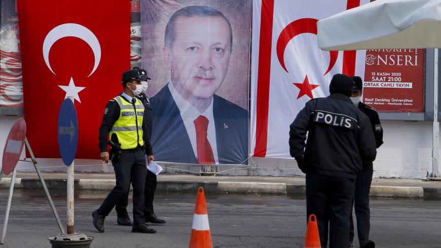 VAROSHA,  CYPRUS - NOVEMBER 15: Turkish Cypriot police stand before portrait of Turkish President Recep Tayyip Erdogan on November 15, 2020 in the disputal coastal town of Varosha, in Famagusta, Cyprus. Erdogan visited the ghost town of Famagusta to have a picnic during a state visit to the self-proclaimed Turkish Republic of North Cyprus (TRNC)(Photo by Alexis Mitas/Getty Images)