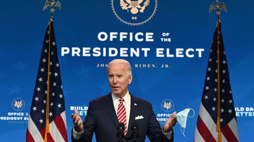 US President-elect Joe Biden shows a face mask as he answers questions about COVID 19 from the press at The Queen in Wilmington, Delaware on November 16, 2020. - US President-elect Joe Biden expressed frustration on November 16, 2020 about Donald Trump's refusal so far to cooperate on the White House transition process, saying "more people may die" without immediate coordination on fighting the coronavirus pandemic. (Photo by ROBERTO SCHMIDT / AFP) (Photo by ROBERTO SCHMIDT/AFP via Getty Images)
