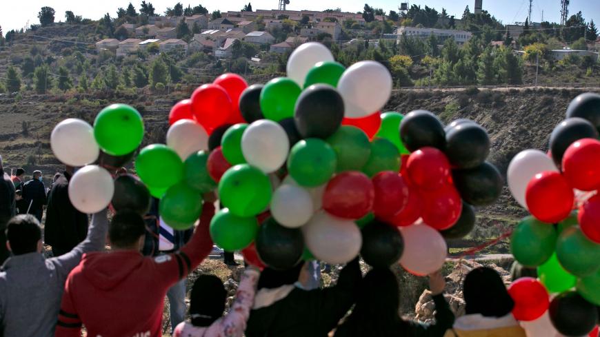 Palestinians demonstrate near the Israeli settlement of Psagot, built on the lands of the city of al-Bireh, against the visit by US Secretary of State's to the settlement, on November 18, 2020 in the occupied West Bank. - US Secretary of State Mike Pompeo was due to arrive in Jerusalem today for a farewell visit as the chief diplomat of the strongly pro-Israeli Trump administration. (Photo by ABBAS MOMANI / AFP) (Photo by ABBAS MOMANI/AFP via Getty Images)