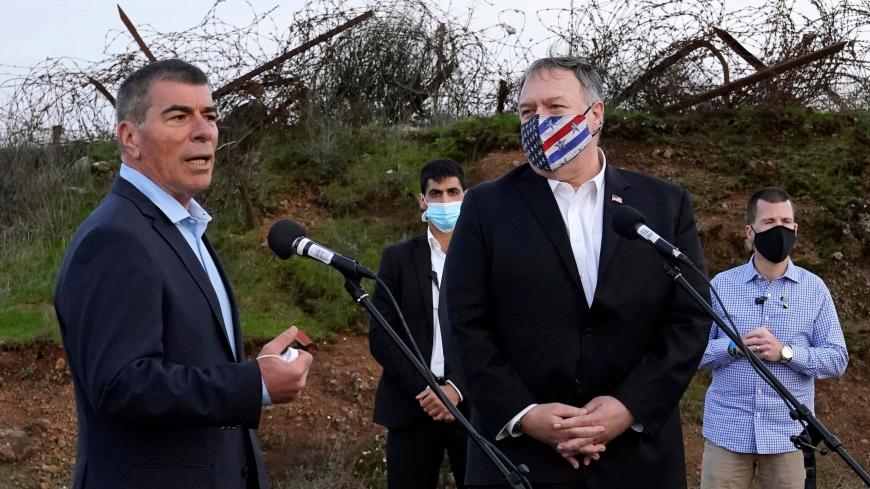 Israeli Foreign Minister Gabi Ashkenazi (L) speaks alongside US Secretary of State Mike Pompeo following a security briefing on Mount Bental in the Israeli-annexed Golan Heights, near Merom Golan on the border with Syria, on November 19, 2020. - US Secretary of State Mike Pompeo became the first top American diplomat to visit a West Bank Jewish settlement and the Golan Heights, cementing Donald Trump's strongly pro-Israel legacy. (Photo by Patrick Semansky / POOL / AFP) (Photo by PATRICK SEMANSKY/POOL/AFP v