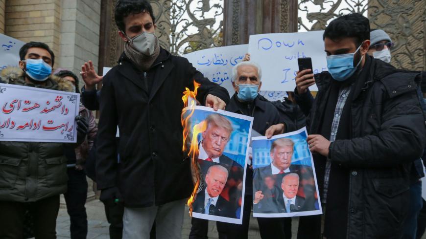 Students of Iran's Basij paramilitary force burn posters depicting US President Donald Trump (top) and President-elect Joe Biden, during a rally in front of the foreign ministry in Tehran, on November 28, 2020, to protest the killing of prominent nuclear scientist Mohsen Fakhrizadeh a day earlier near the capital. - Iran's President Hassan Rouhani accused arch-foe Israel of acting as a "mercenary" for the US and seeking to create chaos, blaming it for the assassination of a top Iranian nuclear scientist. (P