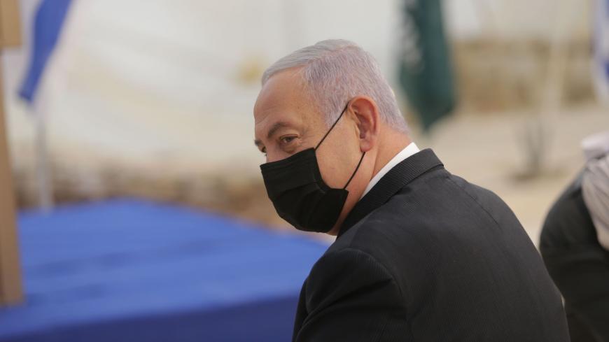 Israeli Prime Minister Benjamin Netanyahu, mask-clad due to the COVID-19 coronavirus pandemic, attends the opening ceremony for Sha'ar Hagay national site, near Jerusalem on November 29, 2020. (Photo by Alex KOLOMIENSKY / POOL / AFP) (Photo by ALEX KOLOMIENSKY/POOL/AFP via Getty Images)
