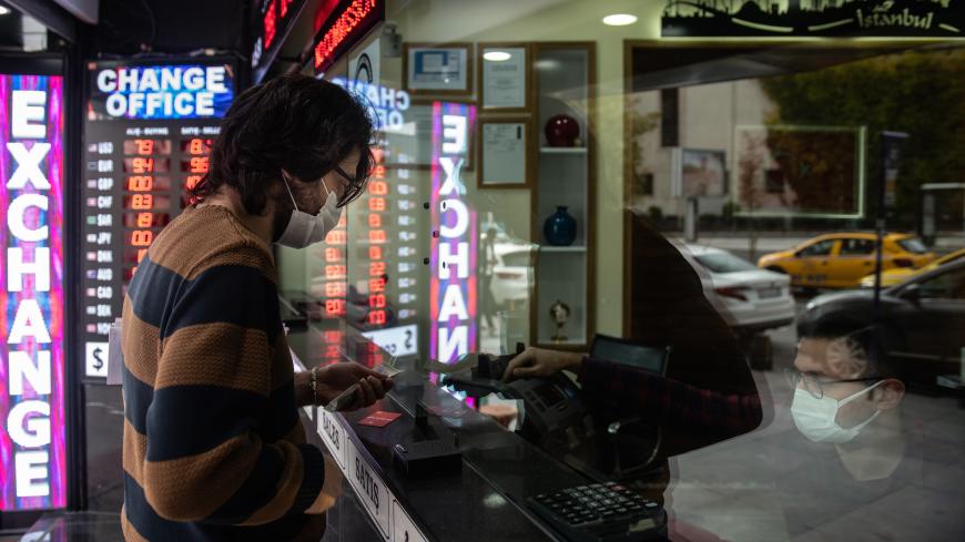 ISTANBUL, TURKEY - NOVEMBER 09: A man exchanges money at a currency exchange shop on November 09, 2020 in Istanbul, Turkey. Finance Minister Berat Albayrak, the son-in-law of President Erdogan who has been in the role for five years, resigned Sunday citing health reasons. The country's currency has plunged 30 percent this year. After the resignation of Berat Albayrak, Turkish lira gained 3% against $ following the resignation. (Photo by Burak Kara/Getty Images)