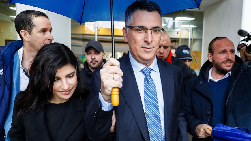 Gideon Saar (C), Israeli Member of Knesset for Likud, accompanied by his wife Geula Even Saar (L), leave a polling station after casting his ballot during a primary election vote to elect the party chairman, in the coastal city of Tel Aviv, on December 26, 2019. - Saar is the only challenger for incumbent Prime Minister Benjamin Netanyahu for the Likud party leadership ahead of the scheduled general elections in 2020. (Photo by JACK GUEZ / AFP) (Photo by JACK GUEZ/AFP via Getty Images)