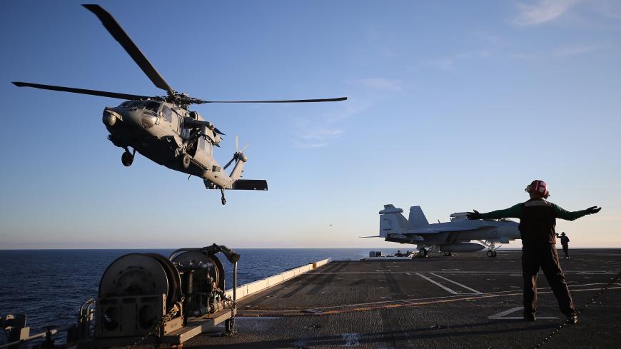 AT SEA - JANUARY 18: A U.S. Navy helicopter descends to land on the flight deck of the USS Nimitz (CVN 68) aircraft carrier while at sea on January 18, 2020 off the coast of Baja California, Mexico. The USS Nimitz is currently conducting routine operations and training at sea. The nuclear-powered aircraft carrier holds a flight deck area of 4.5 acres and can hold 65 aircraft along with nearly 5,000 total personnel. It is the oldest U.S. Navy carrier in active service and was commissioned on May 3, 1975. (Ph