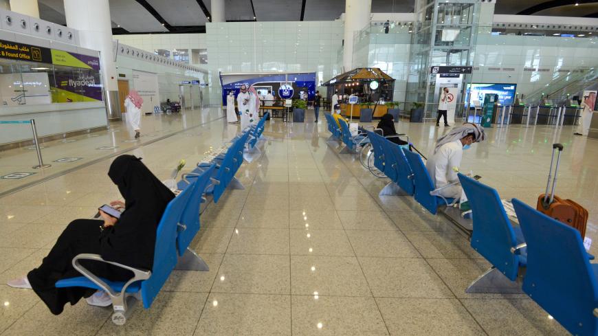 Saudi passengers observe a safe distance as they wait their fligts at terminal 5 in the King Fahad International Airport, designated for domestic flights, in the capital Riyadh on May 31, 2020, after authorities lifted the ban on flights within the country. (Photo by FAYEZ NURELDINE / AFP) (Photo by FAYEZ NURELDINE/AFP via Getty Images)