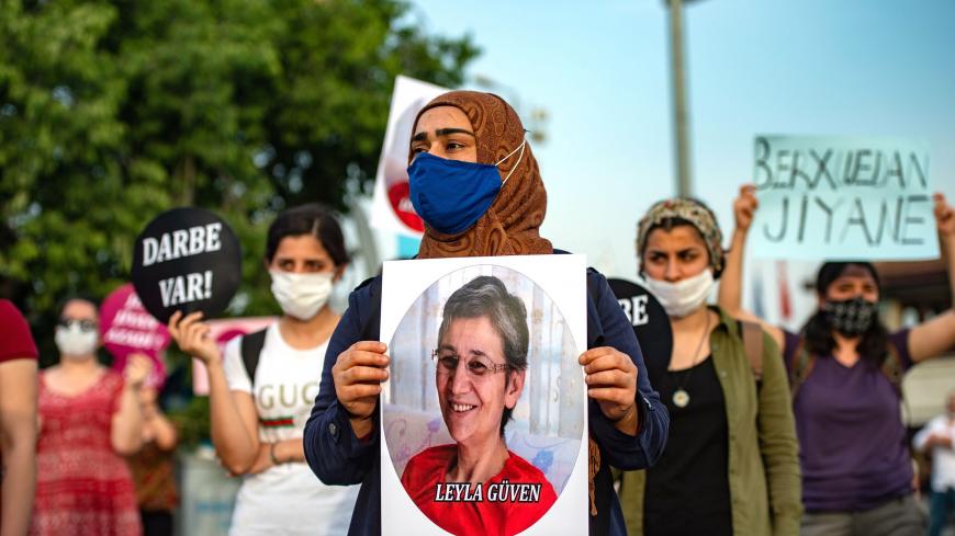A demonstrator holds a picture of HDP lawmaker Leyla Guven during a protest against the detention of three opposition lawmakers, in Istanbul, Turkey, on June 6, 2020. - Turkish police on June 4, 2020 detained three opposition lawmakers after the parliament stripped them of their jobs, triggering furious charges that President Recep Tayyip Erdogan's government is seeking to further consolidate authoritarian rule. (Photo by Yasin AKGUL / AFP) (Photo by YASIN AKGUL/AFP via Getty Images)