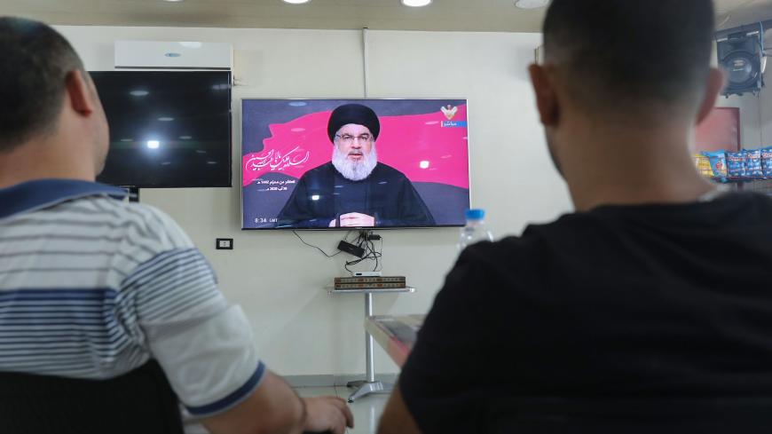 Lebanese men watch the head of the country's Shiite Muslim movement Hezbollah Hassan Nasrallah during a televised speech, at a coffee shop in the southern suburbs of the capital Beirut, on August 30, 2020, on the tenth day of the month of Muharram which marks the peak of Ashura. - Ashura is a 10-day period of mourning in remembrance of the seventh-century martyrdom Imam Hussein, who was killed in the battle of Karbala in modern-day Iraq, in 680 AD. (Photo by ANWAR AMRO / AFP) (Photo by ANWAR AMRO/AFP via Ge