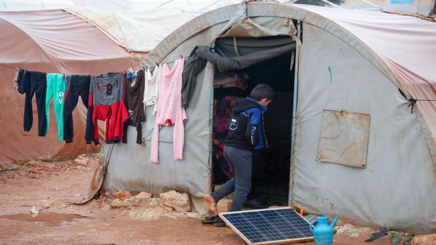 A boy enters a tent at the Batinta camp for the internally displaced, after heavy rainfall in the north of Syria's northwestern Idlib province, on November 26, 2020. (Photo by OMAR HAJ KADOUR / AFP) (Photo by OMAR HAJ KADOUR/AFP via Getty Images)