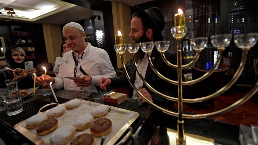 A Hanukkah menorah is seen as Israeli entrepreneurs celebrate the Jewish holiday of Hanukkah for the first time at a hotel in Dubai on December 10, 2020. - Hanukkah commemorates the rededication of the holy temple in Jerusalem after the 165 BC Jewish victory over the Hellenistic Seleucid armies of Antiochus IV Epiphanies, who had outlawed Jewish rituals and ordered Jews to worship Greek gods and adopt their customs. (Photo by Karim SAHIB / AFP) (Photo by KARIM SAHIB/AFP via Getty Images)