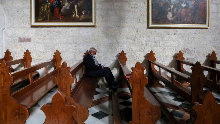 A man is pictured in the Church of the Nativity, in the West Bank city of Bethlehem, on December 20, 2020 after it was re-opened for prayers following strict COVID-19 restrtictions. (Photo by HAZEM BADER / AFP) (Photo by HAZEM BADER/AFP via Getty Images)