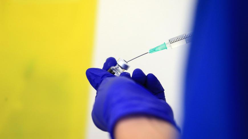Nurse Practitioner Terri Welch prepares a dose of the Pfizer-BioNTech Covid-19 vaccine, at the Haxby and Wigginton Group Medical Practice in Haxby, northern England on December 22, 2020. - Europe is expected to start a massive vaccination campaign after Christmas following the United States and Britain, which have begun giving jabs with an approved Pfizer-BioNTech shot, one of several leading candidates. (Photo by Lindsey Parnaby / AFP) (Photo by LINDSEY PARNABY/AFP via Getty Images)