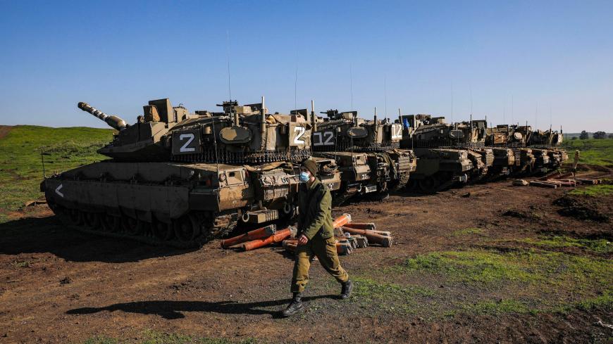 Israeli Merkava battle tanks hold position near Moshav Kidmat Tzvi in the Israeli-annexed Golan Heights on December 25, 2020. - Israeli missile strikes on Syria killed at least six Iran-backed fighters on December 25. The dead were all foreign paramilitaries fighting alongside President Bashar al-Assad's forces, the Syrian Observatory for Human Right said. (Photo by JALAA MAREY / AFP) (Photo by JALAA MAREY/AFP via Getty Images)