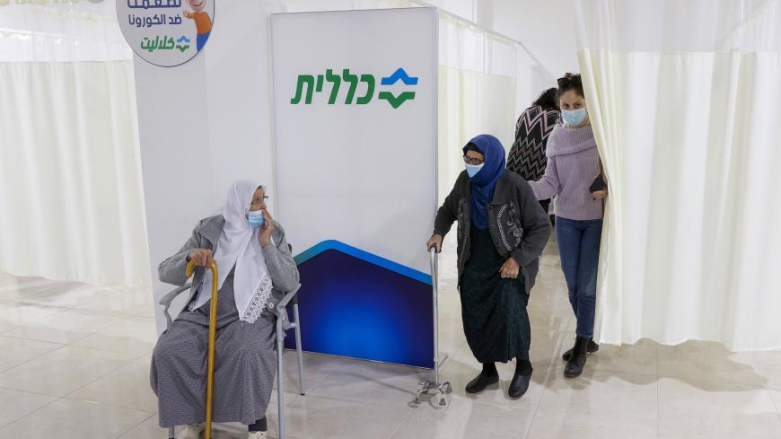 An Arab Israeli woman leaves after receiving a COVID-19 vaccine at Clalit Health Services, in the northern Arab Israeli city of Umm al Fahm , on January 4, 2021. - Israel said Sunday two million people will have received a two-dose Covid-19 vaccination by the end of January, a pace Prime Minister Benjamin Netanyahu boasts is the world's fastest. Health Ministry Director General Hezi Levy said that because of the enthusiastic takeup, Israel would be easing the speed of vaccination to eke out stocks. (Photo b