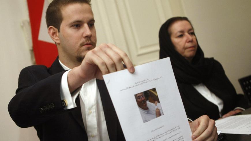US Daniel Levinson (L) shows a picture of his father, ex-FBI agent Robert Levinson, holding his grandson Ryan during a press conference with his mother Christine at the Swiss embassy in Tehran, 22 December 2007. The wife of the former agent missing in Iran since March said today she has received "no answers" about his fate at the end of her trip to the Islamic republic in search of her husband, who Washington says went missing on a visit to the Iranian island of Kish. The Tehran government reiterated earlie
