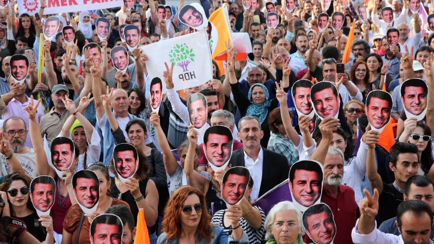 Supporters of imprisoned Selahattin Demirtas, Presidential candidate and leader of People's Democratic Party (HDP) hold masks as they march, during a rally in Ankara, on June 19, 2018. (Photo by ADEM ALTAN / AFP)        (Photo credit should read ADEM ALTAN/AFP via Getty Images)