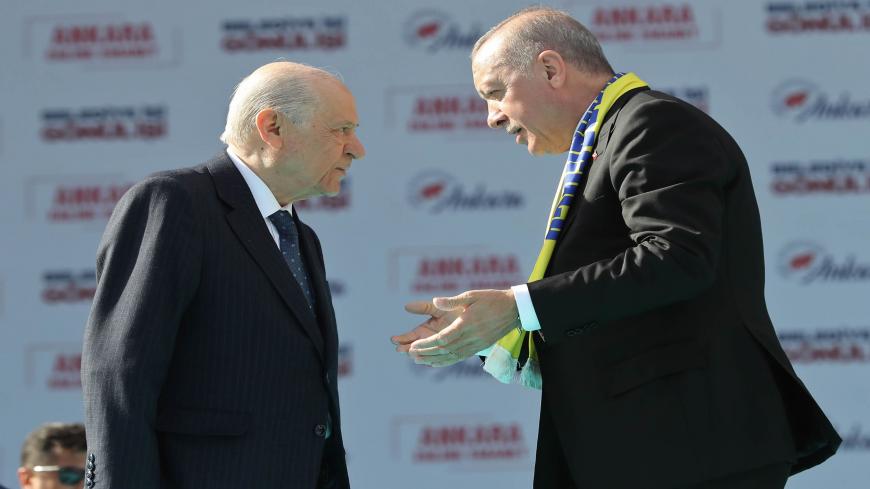 Turkey's President Tayyip Erdogan (R) and leader of the Nationalist Movement Party (MHP) Devlet Bahceli talk on stage during a rally for the upcoming local elections in Ankara, Turkey, on March 23, 2019. - Turkish will cast their ballots for local elections on March 31, 2019. (Photo by Adem ALTAN / AFP)        (Photo credit should read ADEM ALTAN/AFP via Getty Images)