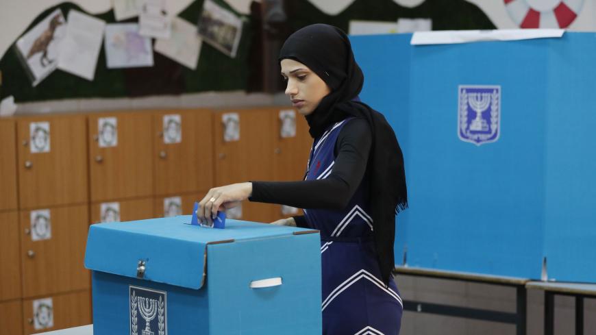 An Arab Israeli woman casts her vote during Israel's parliamentary elections on April 9, 2019 at a polling station in the northern Israeli town of Taiyiba. - Israelis voted today in a high-stakes election that will decide whether to extend Prime Minister Benjamin Netanyahu's long right-wing tenure despite corruption allegations or to replace him with an ex-military chief new to politics. (Photo by Ahmad GHARABLI / AFP)        (Photo credit should read AHMAD GHARABLI/AFP via Getty Images)