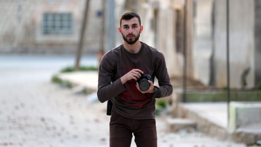 An image taken on February 25, 2019, shows Syrian citizen journalist Anas al-Dyab posing for a picture in the town of Khan Shaykhun in the southern countryside of the rebel-held Idlib province. - The young citizen journalist was among 11 civilians killed in air raids on Syria's Idlib region Sunday, rescue workers and a monitor said, as he filmed the Russia-backed regime bombardment of the battered enclave. Dyab, a photographer and videographer in his early 20s, was a member of the White Helmets who also con