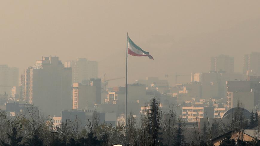 Air pollution covers the Iranian capital Tehran on December 23, 2019. - Schools in Iran's Tehran province have been ordered shut until due to severe air pollution, authorities announced, extending their closure to a full week. Tehran city was cloaked by thick toxic smog for a third successive day on Monday that blanketed out landmarks like Milad Tower and the snow-capped Alborz mountains. (Photo by ATTA KENARE / AFP) (Photo by ATTA KENARE/AFP via Getty Images)