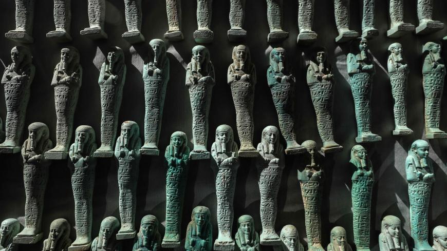 A picture taken on January 30, 2020, shows a collection of Ushabtis or funerary figurines discovered among many archeological finds in 3000-year-old communal tombs dedicated to high priests, in Al-Ghoreifa in Tuna al-Jabal in the Minya governorate. - Egypt's antiquities ministry unveiled 16 tombs of ancient high priests containing 20 sarcophagi, including one dedicated to the sky god Horus, discovered at the archaeological site, about 300 kilometres (186 miles) south of Cairo. The shared tombs were dedicate