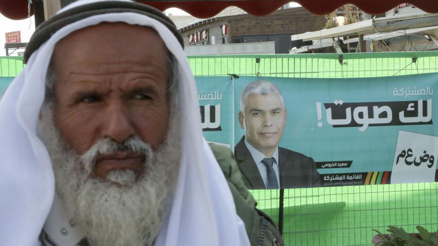 An elderly man from the Negev looks on after registering to vote at the village of Shaqib al-Salam, near the southern Israeli city of Beersheva, on March 1, 2020, on the eve of general elections. The campaign banner in the background is for bedouin member of the parliament (Knesset) Said Al-Khroumi, candidate for the Arab Joint List. (Photo by HAZEM BADER / AFP) (Photo by HAZEM BADER/AFP via Getty Images)