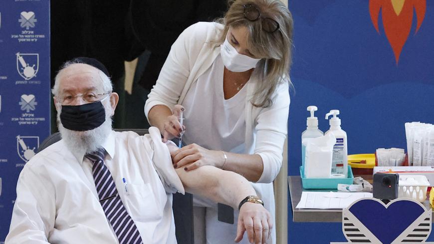 Former Chief Rabbi of Israel Yisrael Meir Lau gets vaccinated against COVID-19 coronavirus at Sourasky Medical Center (Ichilov) in the Israeli coastal city of Tel Aviv, on December 20, 2020. - Israel has ordered 14 million doses of the vaccine -- covering seven million people, as two doses are required per person for optimal protection -- from Pfizer as well as US biotech firm Moderna. The vaccine will be rolled out at 10 hospitals and vaccination centres around Israel for healthcare workers from Sunday, ac