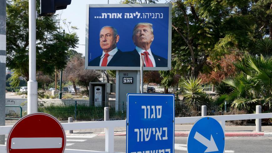 A billboard depicting Israel's Prime Minister Benjamin Netanyahu (L) and US President Donald Trump side by side with a slogan in Hebrew which reads "Netanyahu, a different league", in the Israeli coastal city of Tel Aviv, on January 10, 2021. (Photo by JACK GUEZ / AFP) (Photo by JACK GUEZ/AFP via Getty Images)