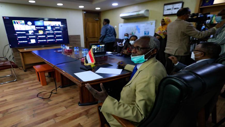 Sudan's Minister of Irrigation and Water Resources Yasser Abbas (L) and Minister for Foreign Affairs Omar Gamar al-Din, are pictured during a video conference meeting with their Egyptian and Ethopian counterparts, to discuss future steps in Grand Ethiopian Renaissance Dam (GERD) negotiations, in the capital Khartoum on January 10, 2021. - Sudan warned today that it cannot continue the "vicious cycle" of negotiations with Egypt and Ethiopia in the long-running dispute over Addis Ababa's controversial Blue Ni