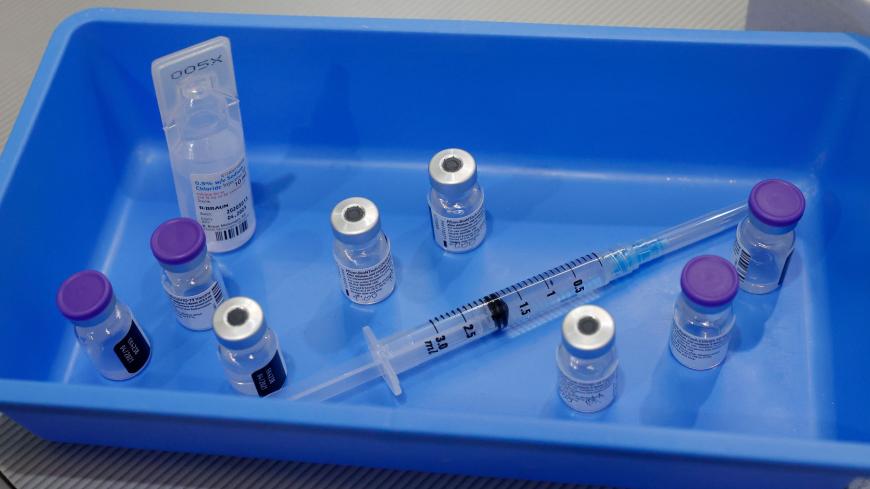 A syringe and vials of the Pfizer-BioNTech COVID-19 vaccine are pictured at the Sheba Medical Center, Israel's largest hospital, in Ramat Gan near the coastal city of Tel Aviv, on January 14, 2021. - Israel's initial vaccination rollout appears to be unfolding successfully, with some two million citizens having received the first of two required injections of the Pfizer-BioNTech jab, a pace widely described as the world's fastest per capita. (Photo by JACK GUEZ / AFP) (Photo by JACK GUEZ/AFP via Getty Image