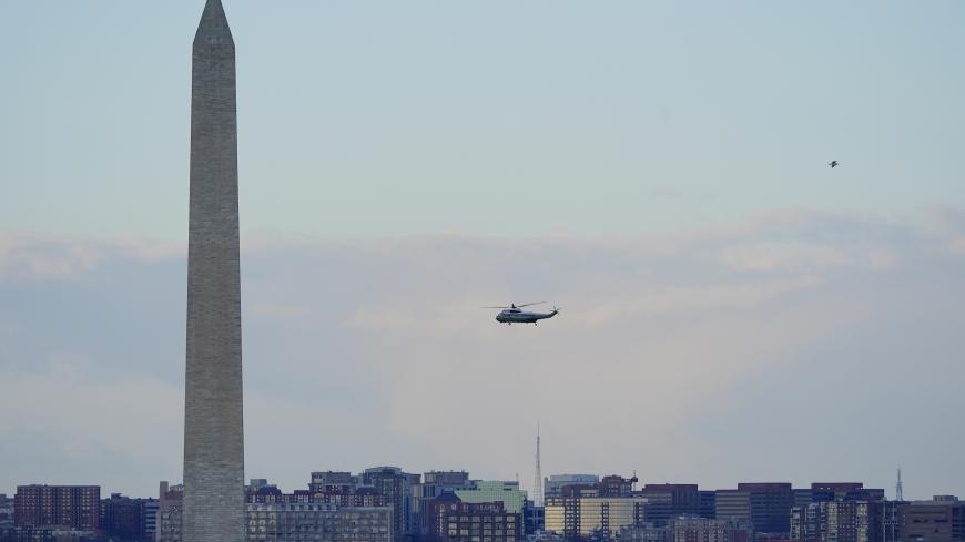 Marine One helicopter, with President Donald Trump and first lady Melania Trump aboard, flies over the National Mall in Washington, Wednesday, Jan. 20, 2021. (AP Photo/Patrick Semansky, Pool)