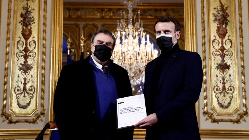 French President Emmanuel Macron (R) poses with French historian Benjamin Stora for the delivery of a report on the colonisation and the Algerian War at the Elysee Palace in Paris on January 20, 2021. - Stora on January 20, 2021, proposed to the French president to create a in France "Memory and Truth" commission, in charge of proposing "common initiatives between France and Algeria on issues of memory" in order to reconcile the two countries. (Photo by CHRISTIAN HARTMANN / POOL / AFP) (Photo by CHRISTIAN H