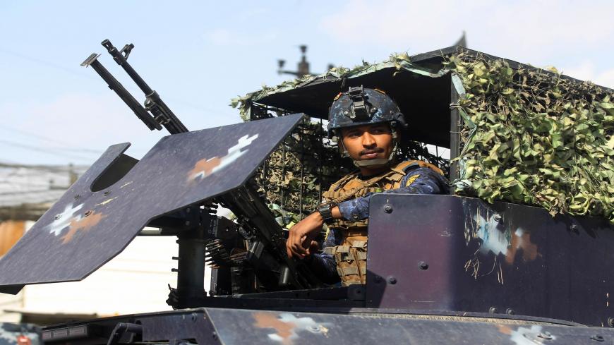 A member of the Iraqi federal police forces sits inside an armoured vehicle at a checkpoint in a street in the capital Baghdad on January 29, 2021, during tightened security measures, a day after a man identified as the top Islamic State (IS) group figure in the country was killed. - Iraq's premier announced yesterday that the military had killed the man, a week after an IS attack in Baghdad killed more than 30 people.
Prime Minister Mustafa al-Kadhemi said IS's Iraq "wali", or governor, Abu Yasser al-Issaw