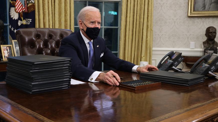 WASHINGTON, DC - JANUARY 20:  U.S. President Joe Biden prepares to sign a series of executive orders at the Resolute Desk in the Oval Office just hours after his inauguration on January 20, 2021 in Washington, DC. Biden became the 46th president of the United States earlier today during the ceremony at the U.S. Capitol.  (Photo by Chip Somodevilla/Getty Images)