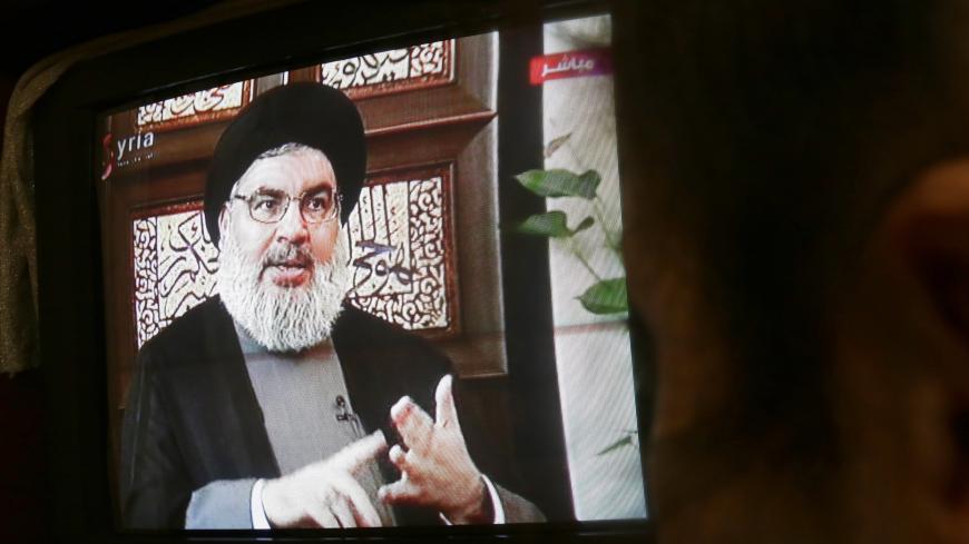 A Syrian watches an interview of Hassan Nasrallah, the head of Lebanon's militant Shiite Muslim movement Hezbollah, screened on Syria's official television channel Al-Ikhbariya on April 6, 2015 in Damascus. AFP PHOTO / STR        (Photo credit should read -/AFP via Getty Images)