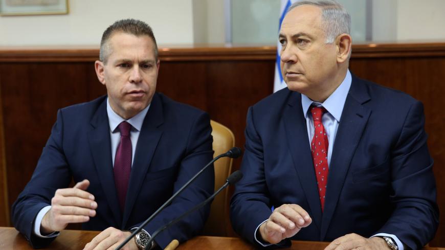 Israeli Prime Minister Benjamin Netanyahu (R) sits next to Israeli Public security Minister Gilad Erdan during the weekly cabinet meeting at his Jerusalem's office on April 10, 2016.  / AFP / POOL / GALI TIBBON        (Photo credit should read GALI TIBBON/AFP via Getty Images)