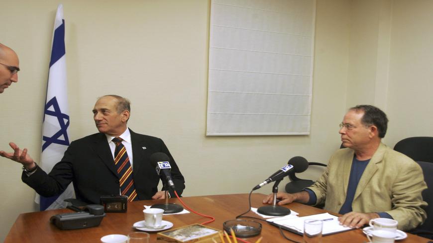 JERUSALEM, ISRAEL - MARCH 20: (ISRAEL OUT) Israeli Acting Prime Minister Ehud Olmert, center, speaks to his media advisor Assi Shariv, left, before he gives an interview to Army Radio personality Razi Barkai at the Ministry of Trade and Industry March 20, 2006 in Jerusalem. One week before Israel's March 28 general elections, Olmert's centrist Kadima party leads its nearest rivals by a nargin of about 2:1 according to opinion polls. (Photo by Uriel Sinai/Getty Images)