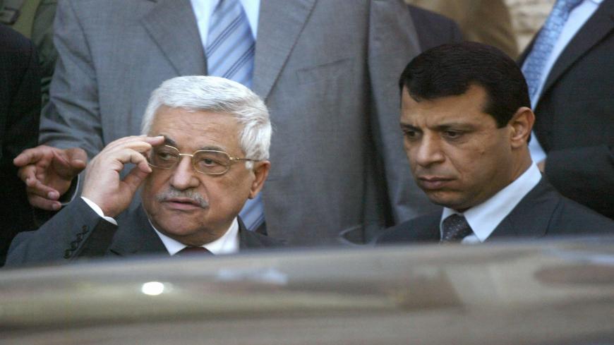 RAMALLAH, -: Palestinian President Mahmud Abbas (L) stands with Mohammad Dahlan, a strongman from the Fatah party, as they watch US Secretary of State Condoleezza Rice leave the Palestinian Authority headquarters or Muqataa in the West Bank city of Ramallah, 25 March 2007. Rice urged Israelis and Palestinians to work together on a common peace agenda after talks with Palestinian president Mahmud Abbas. AFP PHOTO / JAMAL ARURI (Photo credit should read JAMAL ARURI/AFP via Getty Images)